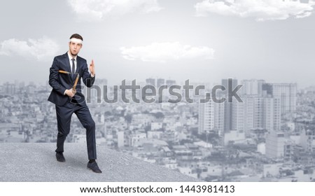 Foto stock: Suited Karate Man Doing Karate Tricks On The Top Of A Metropolitan City