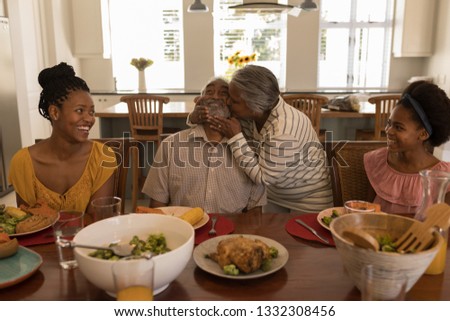 Stock foto: Front View Of African American Senior Woman Kissing Her Husband Surrounded By His Daughter And His G