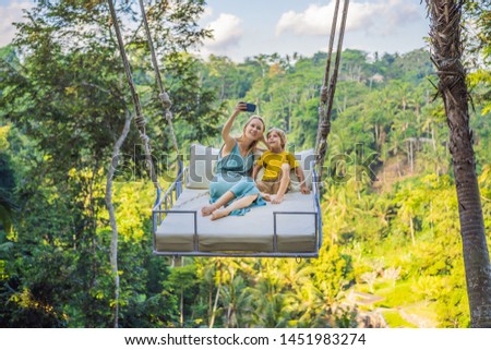 ストックフォト: Mother And Son Swinging In The Jungle Rainforest Of Bali Island Indonesia Swing In The Tropics Sw