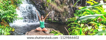 Stock foto: Yoga Woman Meditating At Waterfall Lush Forest In Kauai Hawaii Spiritual Woman Praying Namaste In