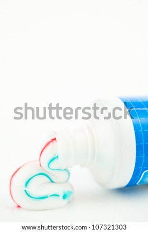 Foto stock: Multicolour Toothpaste Outgoing Of A Tube Of Toothpaste Against White Background