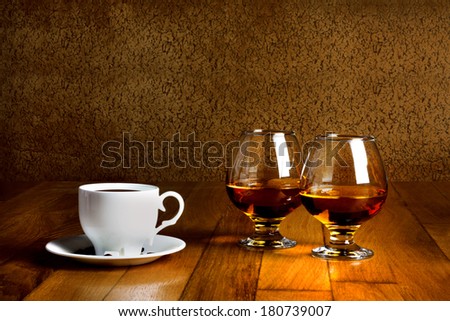 Stockfoto: Two Goblets Of Brandy And Cup Of Hot Coffeeon Wooden Old Counter