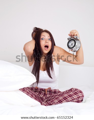 Stock fotó: Oldogtalan · lány · túl · későn · ébredt, · és · nézte · az · ébresztőórát