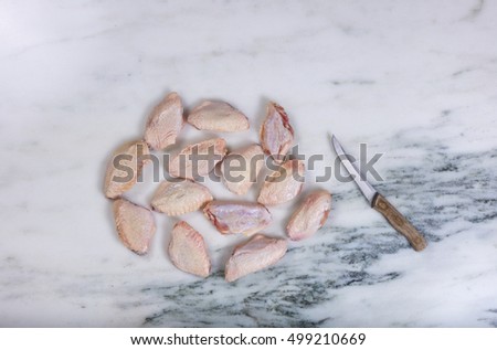 Foto stock: Fresh Raw Chicken Wings And Kitchen Knife On Marble Stone Counte