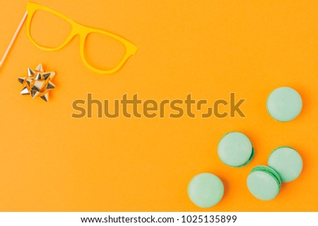 Stock photo: Top View Of Party Mask Bow And Macarons Isolated On Orange Purim Holiday Concept