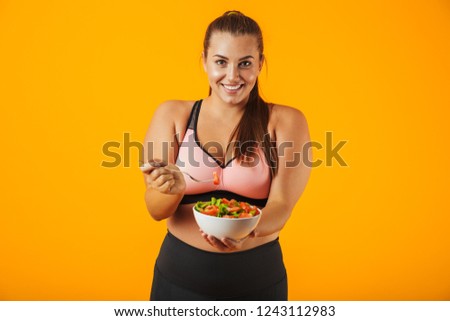 Foto d'archivio: Portrait Of European Chubby Woman In Sportive Bra Holding Copysp