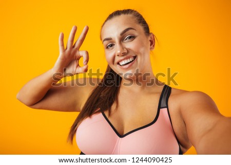 Stock foto: Portrait Of Cheerful Chubby Woman In Sportive Bra Using Mobile P