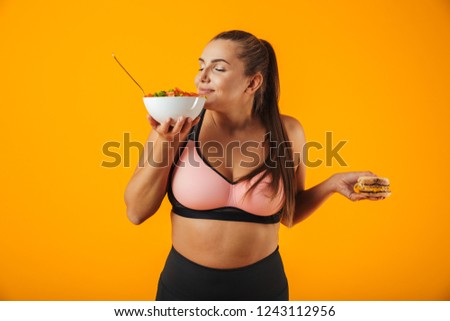 Stok fotoğraf: Image Of Pleased Chubby Woman In Tracksuit Eating Green Salad Fr
