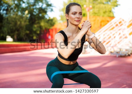 Stock photo: Photo Of Beautiful Sporty Woman 20s In Tracksuit Doing Sit Ups