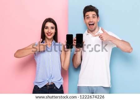 Zdjęcia stock: Image Of Optimistic Man And Woman In Casual Wear Holding Mobile