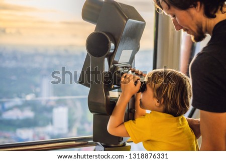 Stock foto: Dad And Son Are Looking At Kuala Lumpur Cityscape Use Binocular