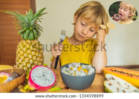 ストックフォト: Boy Eats Fruit But Dreams About Donuts Harmful And Healthy Food For Children Child Eating Healthy