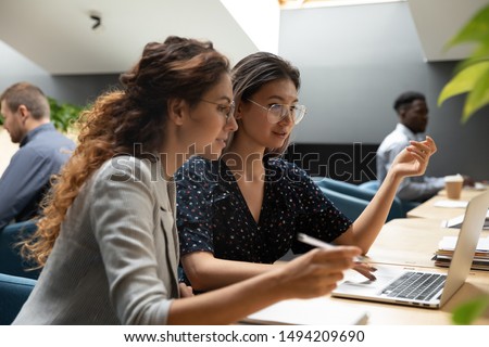 [[stock_photo]]: Two Young Creative Designers Of Software Discussing New Interfaces Of Smartphone