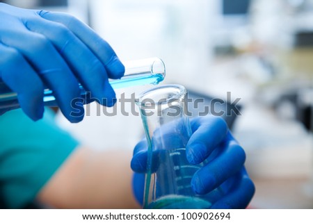 Stockfoto: Gloved Hands Of Biologist Or Scientist Holding Flask With Plant In Water