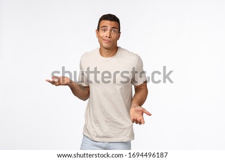 Stockfoto: Clueless Handsome Young Hispanic Muscular Man In Casual T Shirt Shrugging Spread Arms Sideways Sm