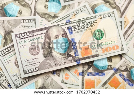 Foto stock: Pile Of One Hundred Dollar Bills With Medical Face Mask On Face
