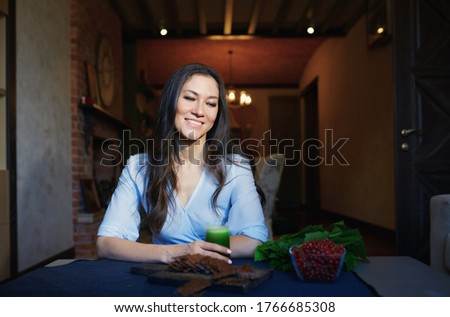 Stockfoto: Smiling Vegetarian Woman Sitting At The Table With Celery Fresh