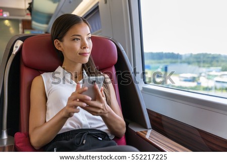 Asian Woman Relaxing In Train Seat While Using Smartphone App Chinese Businesswoman Enjoying View T Stockfoto © Maridav