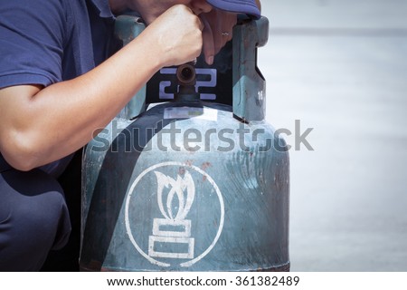 Stock photo: Cigarette In Hand Near Gas Tank Cylinder Can Ignition Of Flammab