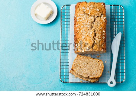 Stok fotoğraf: Healthy Vegan Oat And Coconut Loaf Bread Cake On A Cooling Rack Blue Stone Background
