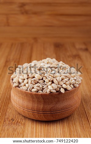 Stock photo: Pearl Barley In Wooden Bowl On Brown Bamboo Board Closeup Rustic Style Healthy Dietary Groats Ba