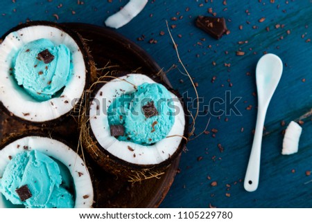 Stockfoto: Blue Ice Cream With Chocolate In Coconut Bowl On Wooden Background