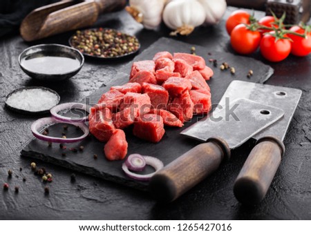 Foto stock: Raw Lean Diced Casserole Beef Pork Steak On Chopping Board With Vintage Meat Hatchets On Brown Backg