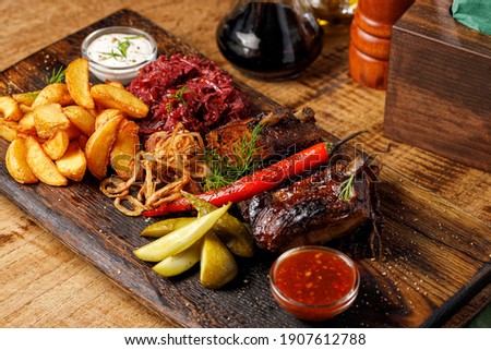 Stock fotó: Steak Pork Grill On Wooden Cutting Board With A Variety Of Grilled Vegetables