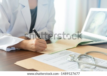 Stok fotoğraf: Doctor Taking Notes