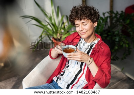 Сток-фото: Serene Brunette Woman In Casualwear Enjoying Day Off While Having Tea