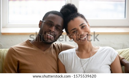 Stock photo: Indoor Shot Of Cheerful Husband And Wife Look With Joyful Expressions Laugh As Watch Funny Movie R