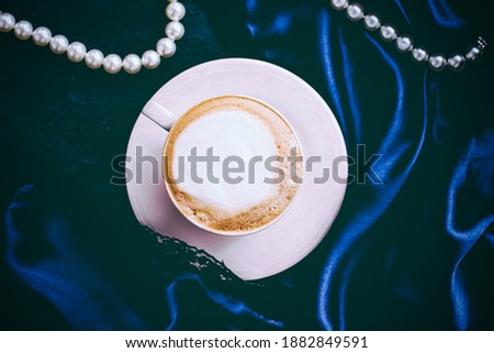 Stok fotoğraf: Cup Of Cappuccino For Breakfast With Satin And Pearls Jewellery