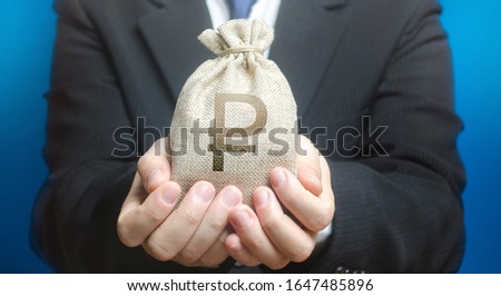 Foto d'archivio: Man Holds Out A Russian Ruble Money Bag Provision Of Money On Credit Grant Project Financing Don