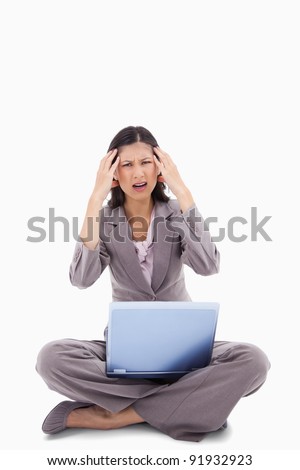 Foto stock: Laptop Gives Sitting Woman A Headache Against A White Background