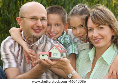 Stok fotoğraf: Family With Two Children Is Keeping Wendy House In Their Hands And Looking At It Focus On Wendy Hou
