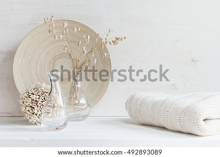 Foto stock: Soft Home Decor Of Glass Vase With Spikelets And Knitted Fabric On White Wood Background