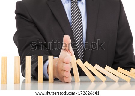 Foto stock: Businessman Hand Stop Dominoes Continuous Toppled Or Risk With C