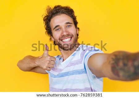 Foto stock: Image Of Successful Man In Striped T Shirt Smiling While Holding