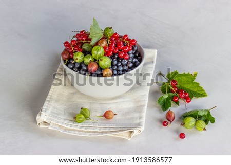 Stok fotoğraf: Fresh Raw Organic Berries In White Ceramic Bowl Plate On Kitchen Table Background Space For Text T