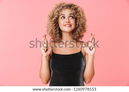 Foto d'archivio: Portrait Of Pleased Curly Woman 20s Wearing Dress Keeping Finger