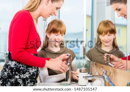 ストックフォト: Woman Checking A Bathroom Sink Faucet In A Modern Sanitary Ware Shop