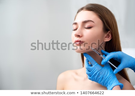 Stok fotoğraf: Beautician Doing Beauty Injection To Woman Lips