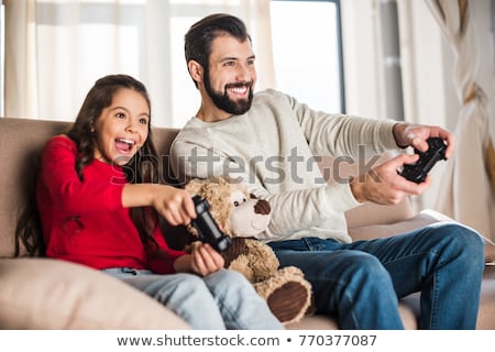 Stock photo: Father And Daughter Playing Video Game At Home