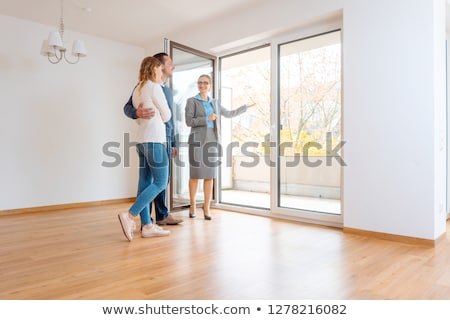 Сток-фото: Young Couple Getting Tour Through Apartment They Consider Renting