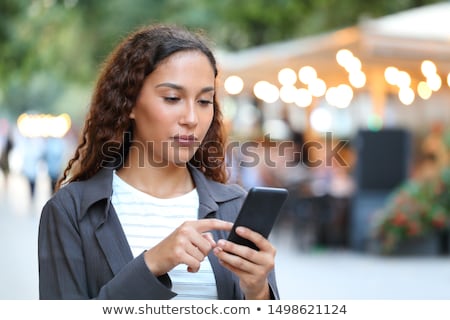 Stock foto: Young Woman With Cell Phone Walking