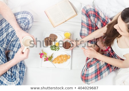 Stock photo: Couple Having Breakfast Together On Sofa