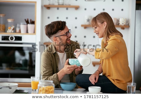 Foto d'archivio: Young Couple Making And Tasting Salad