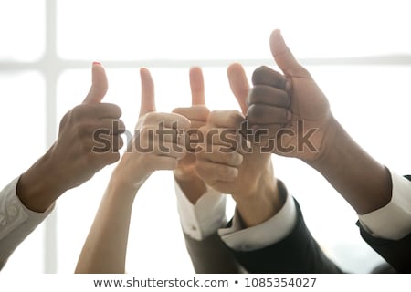 Foto stock: Business Team Celebrating A Triumph With Thumbs Up