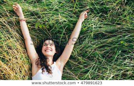 Сток-фото: Smiling Pretty Young Woman Lying On The Grasses