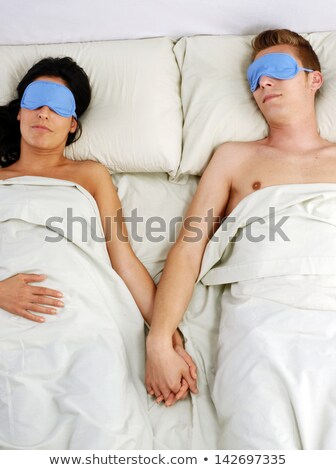 Stockfoto: Couple Sleeping On Bed Using Eye Mask